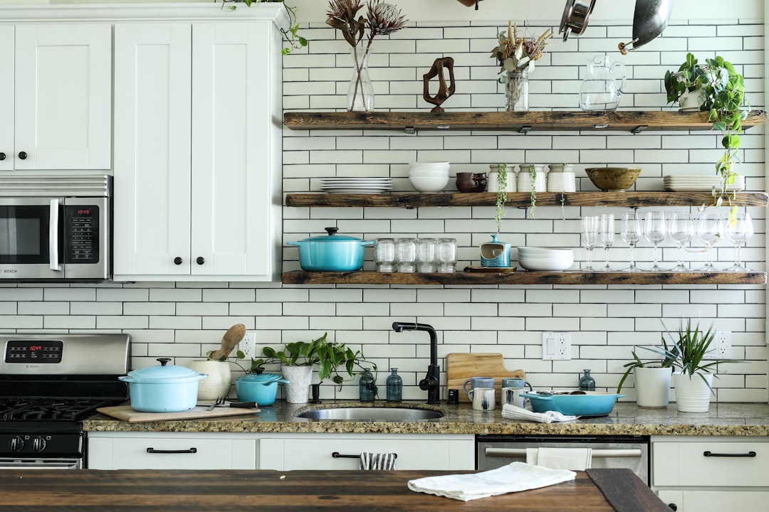 A collection of essential kitchen tools including knives, cutting boards, measuring cups, and utensils arranged on a countertop.