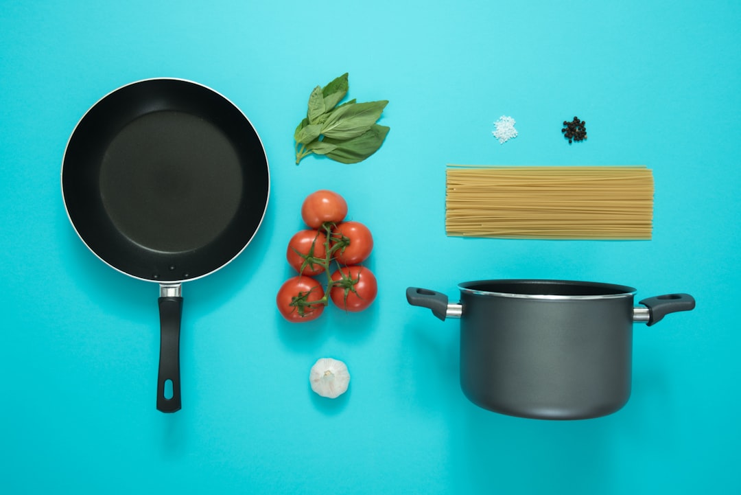 A variety of pots and pans arranged on a kitchen countertop, showcasing different materials and sizes suitable for everyday cooking.