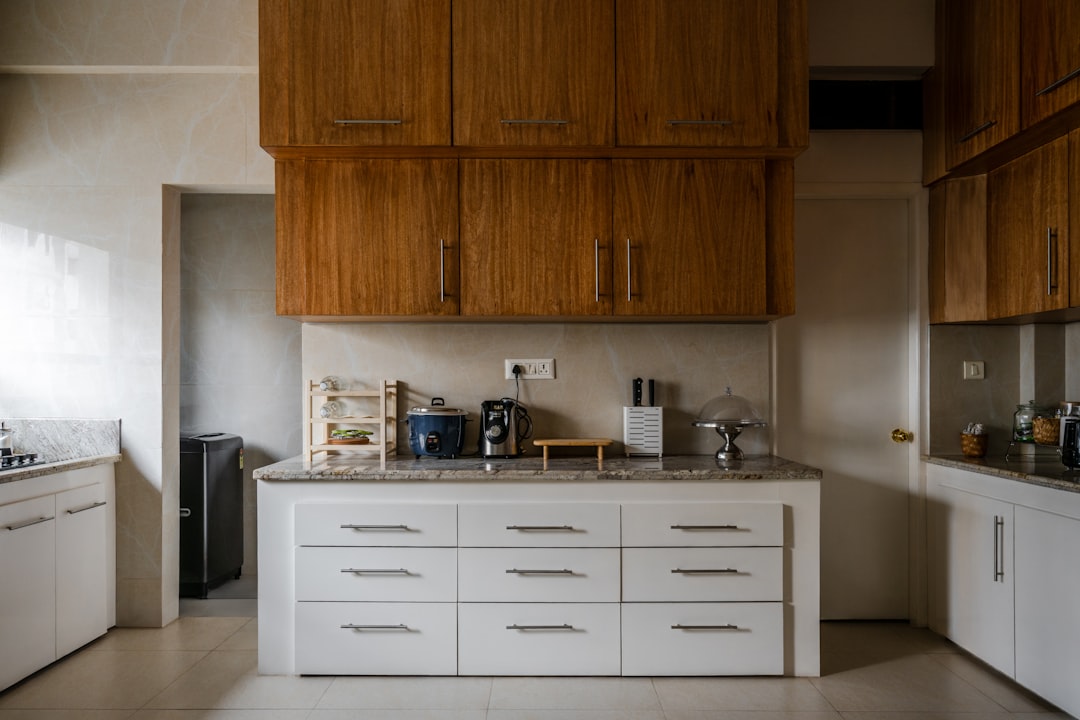 A neatly organized kitchen cabinet with labeled containers and arranged utensils, showcasing an efficient storage system.